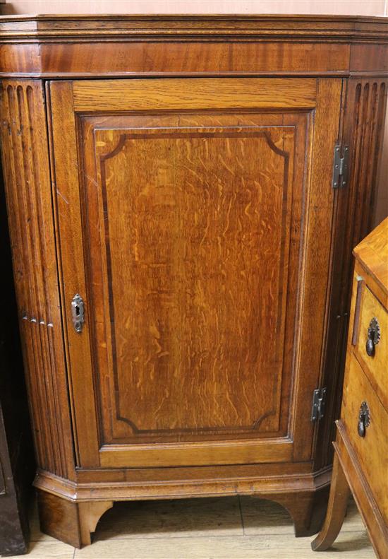 A Georgian oak corner cupboard, W.116cm